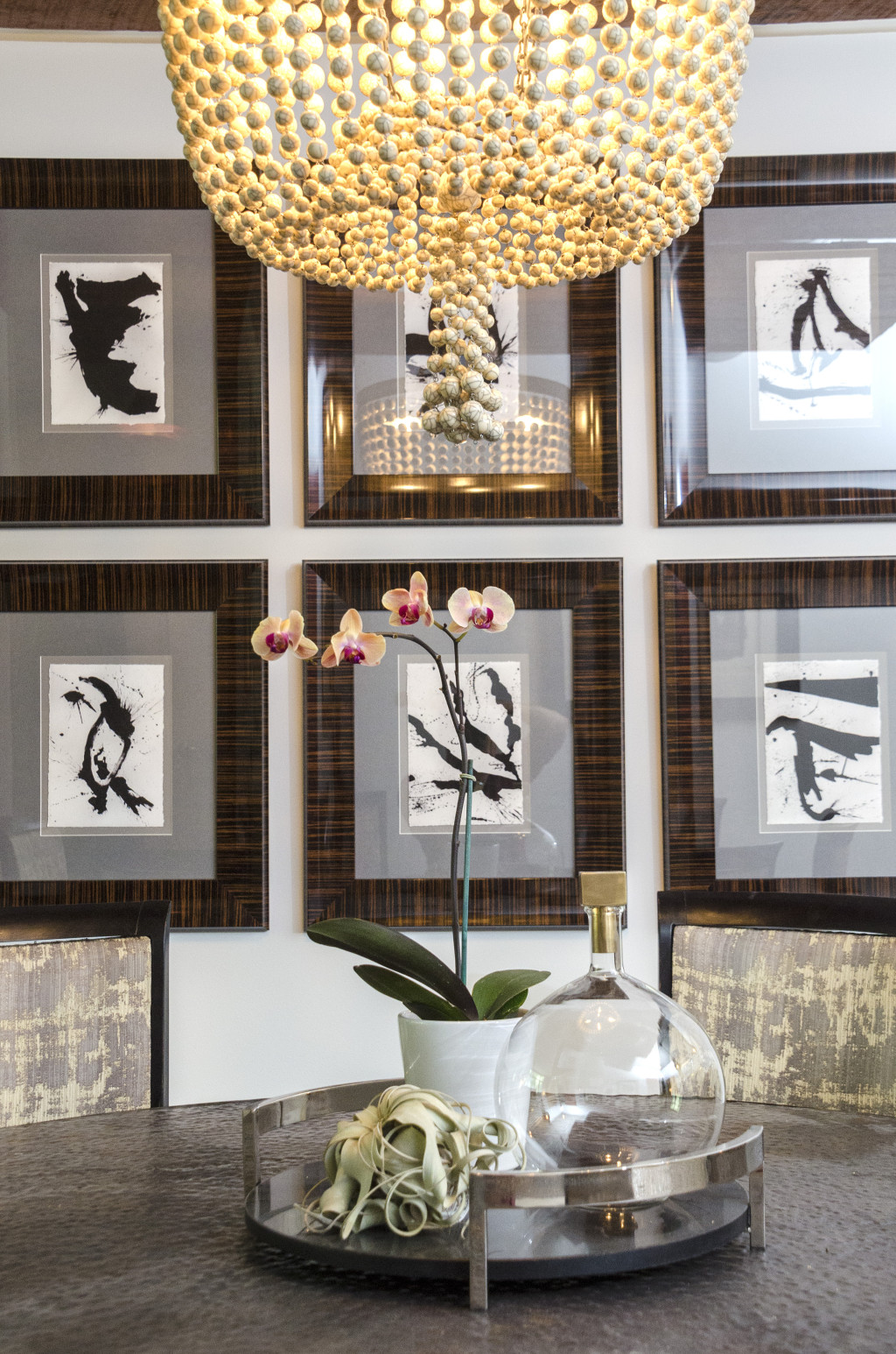 Dining room detail with chandelier and art wall styling