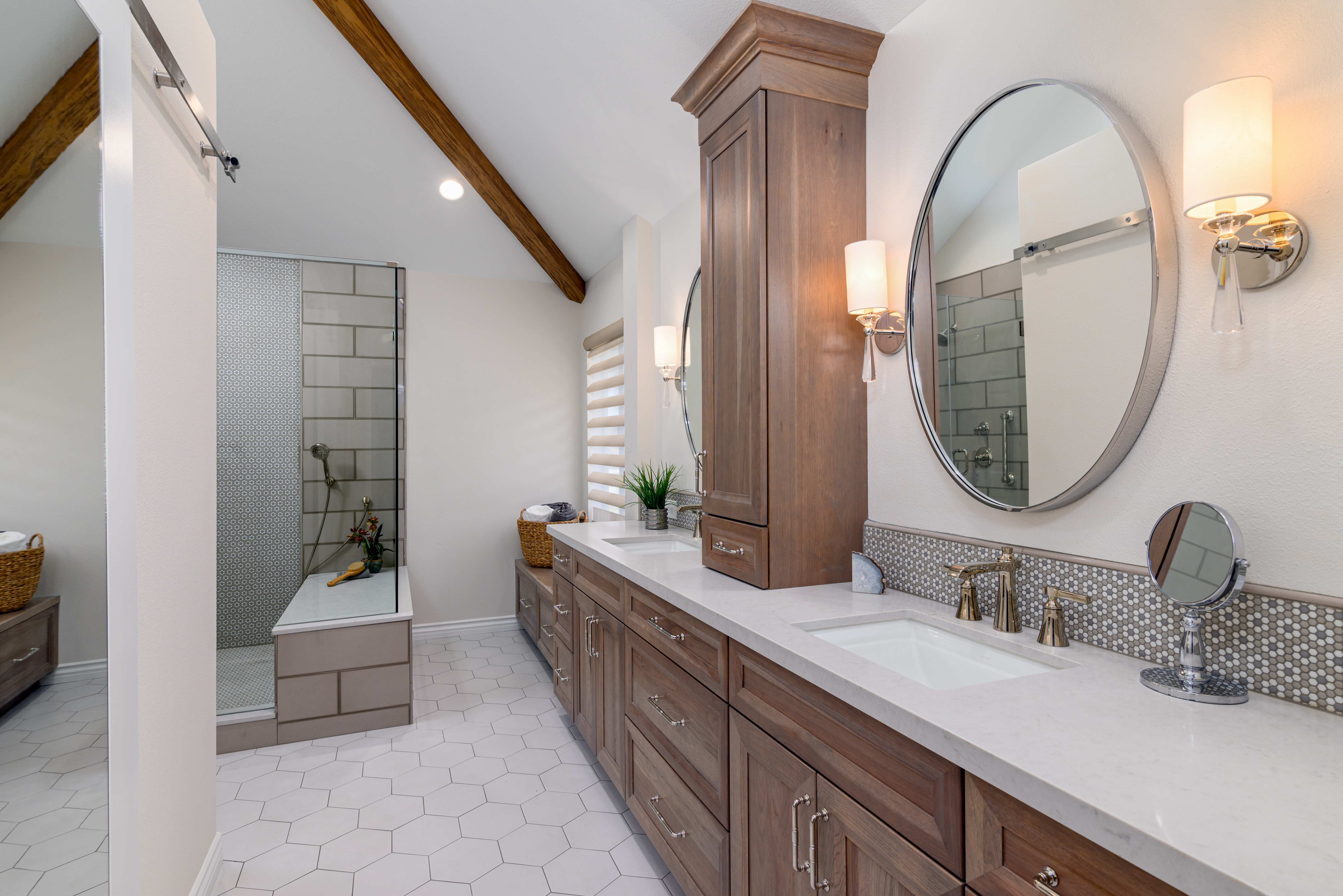 Master bathroom with walnut vanity and vaulted ceiling